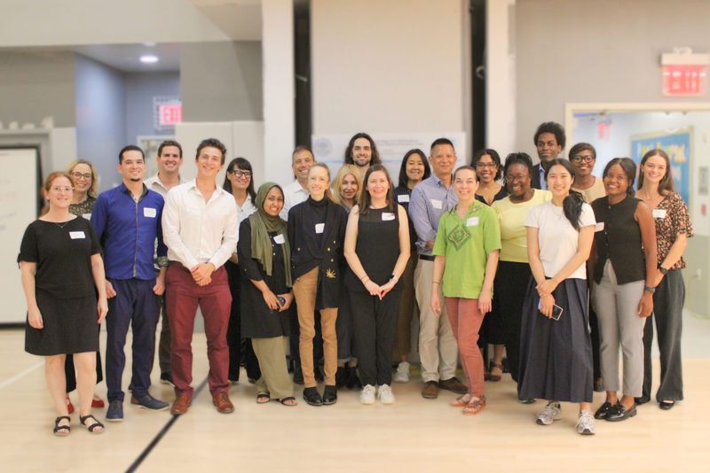 A large group of street-based mental health clinicians and trainees standing together at the 2025 Street Psychiatry Conference.